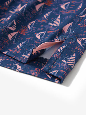 Close-up of the hem vent on the navy sailboat 4 way stretch print collared polo shirt, showing the side split for movement