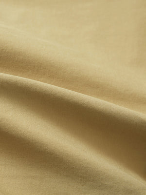 Close-up texture of khaki flat front flex cotton blend golf shorts fabric showing detailed cotton blend material and weave.