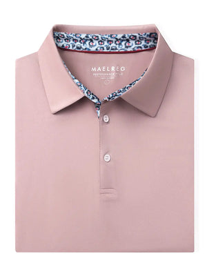 Folded Pale Pink Everyday Classic Solid Polo neatly laid out for display