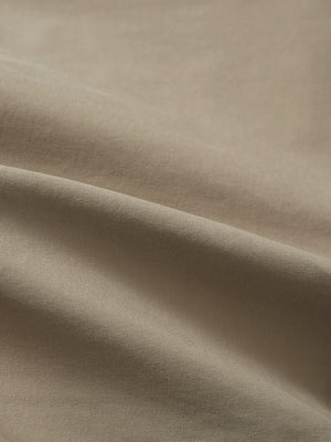 Close-up texture of khaki grey flat front flex cotton blend golf shorts fabric showing detailed cotton blend material and weave.