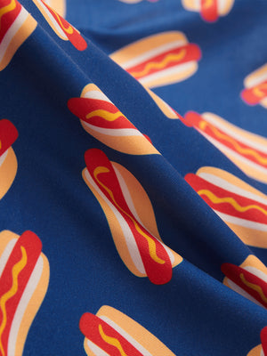Close-up of hot dog golf performance print boys golf polo, showcasing texture and print details.