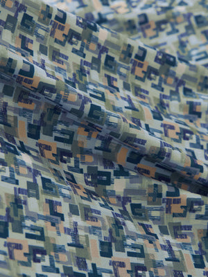 Close-up of blue abstract stretch printed collarless henley golf shirts, showcasing texture and print details.