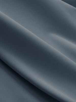 Close-up texture of gray blue breathable casual slacks with 4 pockets fabric showing detailed breathable material and weave.