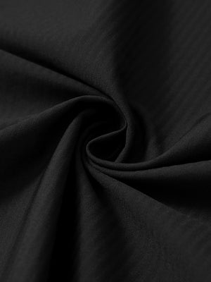 Close-up fabric detail of lightweight water-resistant outerwear jacket, smooth black texture