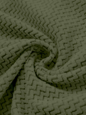 Fabric close-up of warm stretchy quarter zip with pocket, smooth knit texture and flexible feel in green