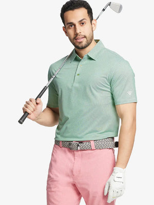 Model front half-body holding golf club wearing EMERALD Performance Ananas Jacquard Polo