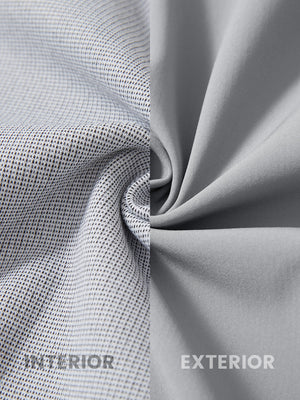 Close-up of fabric on water-resistant heat-tech softshell winter jacket with hood, showing texture in light grey.