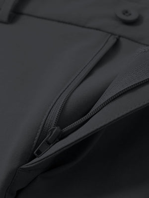 Detail view of the zipper on the dark grey youth water resistant cotton blend golf pants, highlighting secure closure