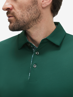 Close-up of a model wearing the blackish green everyday classic solid polo, focusing on the collar and chest area