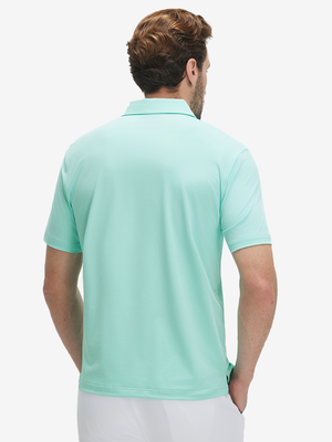 Back half-body view of a model wearing the aqua blue everyday classic solid polo, highlighting the tailored rear fit