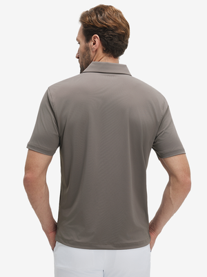 Back half-body view of a model wearing the light brown everyday classic solid polo, highlighting the tailored rear fit