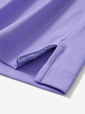 Detail of the side vent hem on the lilac everyday classic solid polo, showing the split hem feature