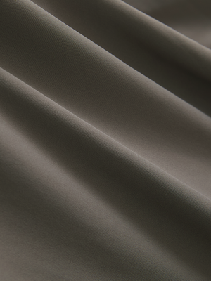 Close-up of the smooth cotton-blend fabric on the light brown everyday classic solid polo