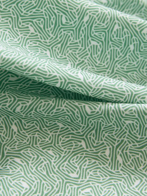 Close-up of green abstract lines lightweight stretch upgraded print golf polo shirts, showcasing texture and print details.