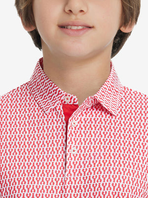 Front view of youth wearing red lobster performance print boys golf polo, showing collar and chest fit