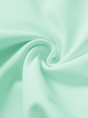 Fabric close-up showing the fleece stretch material of turquoise fleece stretch water resistant boys joggers.