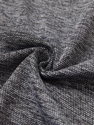 Close-up of fabric on textured insulated winter jacket, showing texture and finish in black heather.